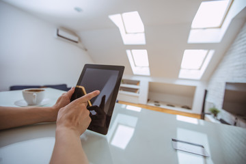 Close up and part of human hand using digital tablet at home