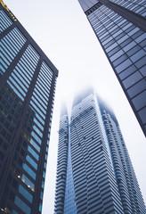 Obraz premium Three skyscrapers ending in the clouds