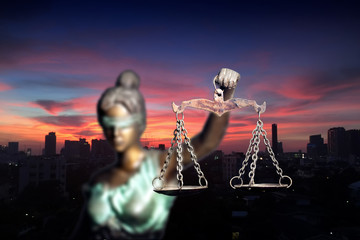 Lady Justice and city in dawn time