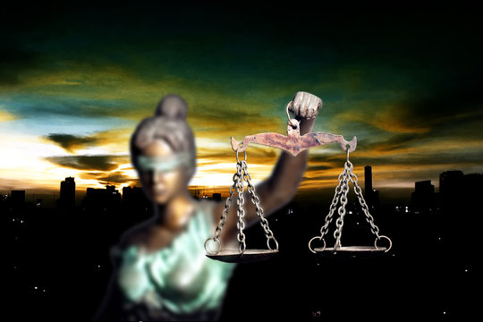 Lady Justice and city in dawn time