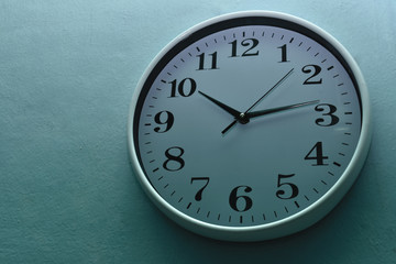 White clock on a blue wall