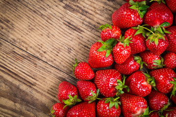 food background with juicy strawberry on wood table and copyspac