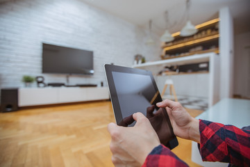 Close up and part of human hand using digital tablet in living room