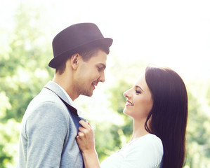 Young beautiful couple of hipsters: hugging in the park. Love, relationship, dating: concept.