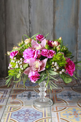 Floral arrangement with orchids, carnations and brunia flowers