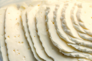 Closeup slices of brined cheese