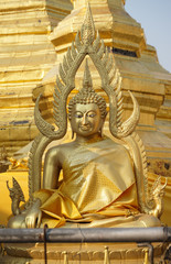 Fototapeta premium Front of sitting Thai Buddha statue that wear golden clothes.
