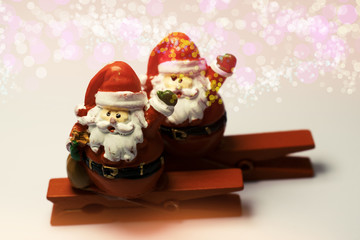Christmas Background with tree decorations. Christmas card. Santa Claus Figurine on cloth pin. 