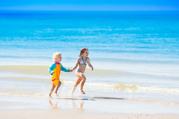 Kids run and play on tropical beach