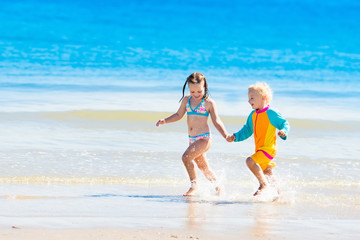 Kids run and play on tropical beach