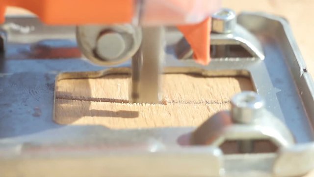 Close-up of a circle of plywood with an automatic jigsaw close-up of a macro on a sunny day