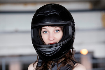 Young Vibrant Intense Girl in black Face Motorcycle Racing Helmet