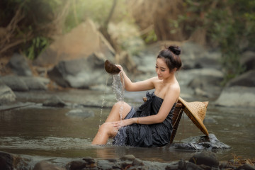 Women in the shower in nature creek forest enjoy on the river relax