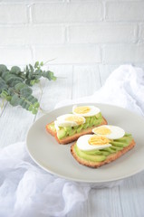Healthy breakfast of toast with avocado and eggs
