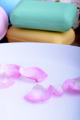 aroma therapy, soap and sea salt on wooden plate