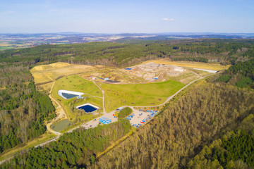 Aerial view of municipal landfill site. Typical waste treatment technology top view. Garbage pile and toxic lakes with dangerous chemicals in trash dump.