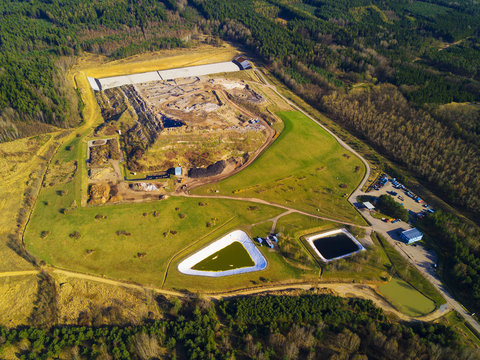 Aerial view of municipal landfill site. Typical waste treatment technology top view. Garbage pile and toxic lakes with dangerous chemicals in trash dump.