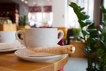 White cup of coffee at the cafe interior