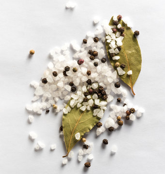 Salt And Mix Of Pepper With Bay Leaves On White Background. Top View.