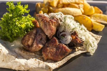 skewers with potatoes and onions on a plate