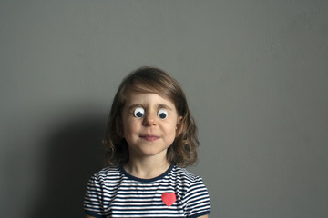 child is kidding: Put doll's plastic eyes