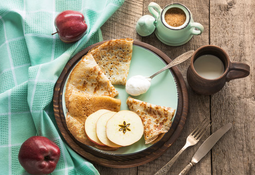 Tasty traditional russian breakfast of slapjack with honey on plate. Rustic style. Space for your text.