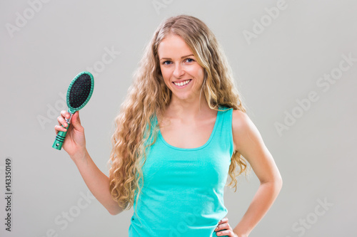 Young Woman Brushing Her Gorgeous Long Blonde Hair Stock Photo And