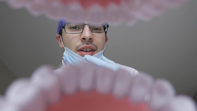 Dentist talking to the patient and explaining something. Personal or patient point of view, POV.