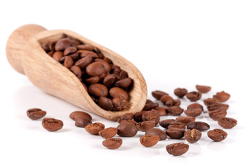 coffee beans in a wooden scoop isolated on white background