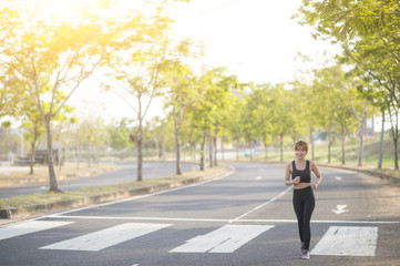 Fototapeta na wymiar young sporty woman running in park