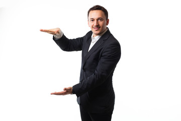 young man in a suit on a white background showing signs