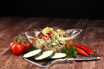 Delicious vegetarian quinoa salad with bell pepper, cucumber and tomatoes