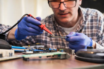 technician soldering motherboard parts 