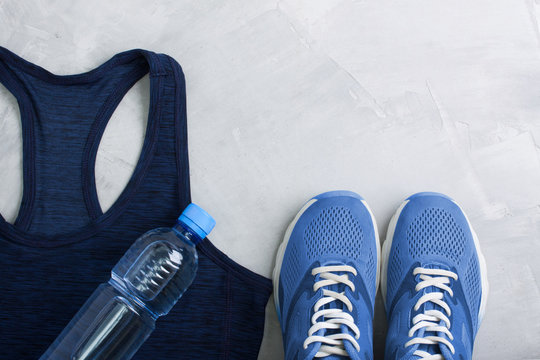 Flatlay sport composition with outfit blue sneakers and t-shirt