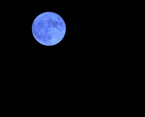 Blue moon in the dark sky on a night