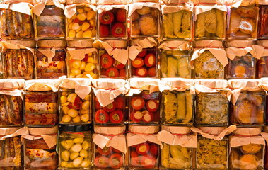 many jars with preserved italian food with  many vegetables