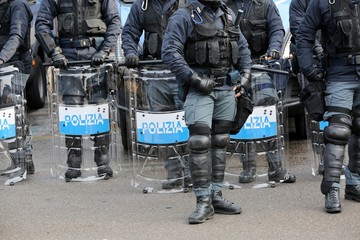police with shields and riot gear during the sporting event