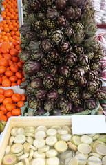 greengrocer with artichoke hearts and mandarins and other fruit