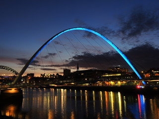 Newcastle upon Tyne, England, United Kingdom. The Gateshead Millennium Bridge and its colors durind evening time