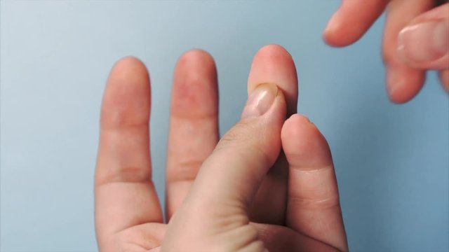 Close up blood sampling from finger. Woman using lancet and test strip on her finger. Flesh blood wound from diabetes patient finger.