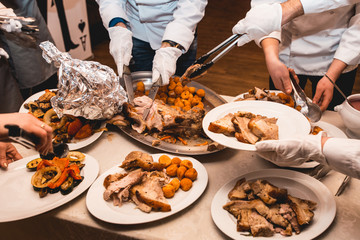 chef cuts roasted meat for restaurant guests