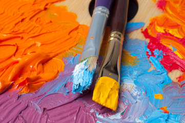 Artist's brushes and color paint stains on a palette