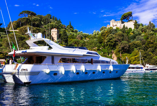 Luxury white yacht in harbour of Portofino, Italy