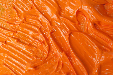 Orange texture of oil paint stains close-up