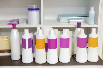 Bottles with different cosmetic on a shelf
