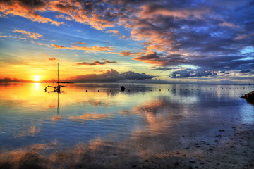 Amazing colorful sunset on the beach of Moorea, French Polynesia. HDR (High dynamic range) picture.