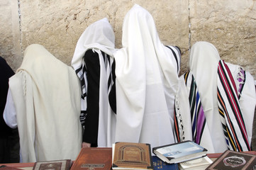 Orthodox Jewish men pray at the Western Wall  in Jerusalem Israel