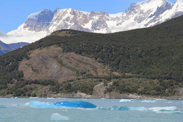 Snow capped mountain and blue iceberg in a lake. El Calafate, Patagonia, Argentina