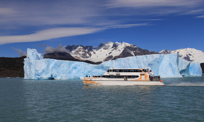 Ship and an iceberg in the background. El Calafate, Patagonia, Argentina
