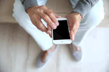 Senior man with smart phone, closeup